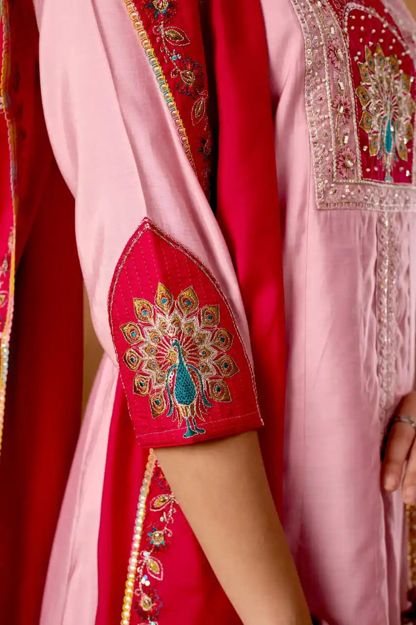 Close-up of a red and pink traditional outfit with intricate embroidery.
